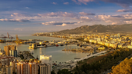 Obraz premium Panoramic City Harbor With Ocean Bay, Docks, and Mountain Range at Sunset in Malaga, Spain