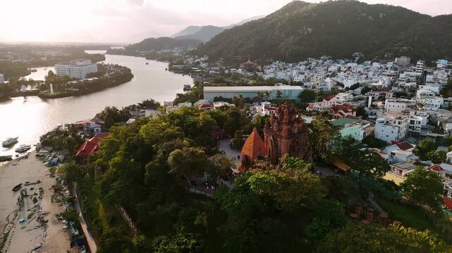 Aerial view of po nagar cham towers at sunset in nha trang, vietnam, with cityscape in the background