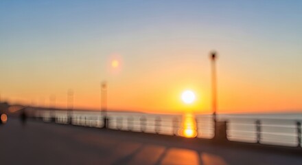 Obraz premium Sunset over pier with railing and lamp post.