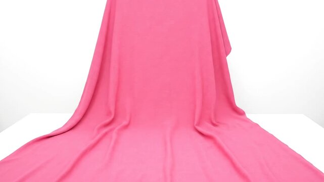 Pink fabric draped on a white surface, smooth folds and creases