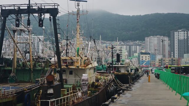 Docked boats in Busan harbor cityscape