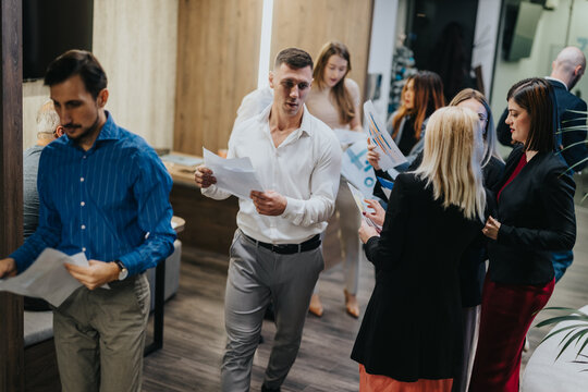 A group of colleagues reviews papers in a contemporary office, creating a collaborative, professional atmosphere.