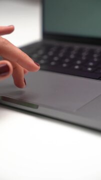 Close-up of hand gesture on notebook trackpad