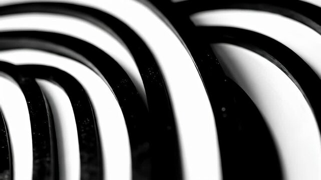 Close-up of black & white concentric curves; monochrome, stark contrast, smooth texture