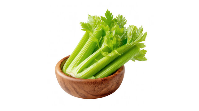 Fresh green celery stalks with leafy tops in a rustic wooden bowl isolated on white background