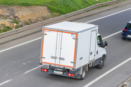 White iveco daily refrigerated delivery van driving on highway