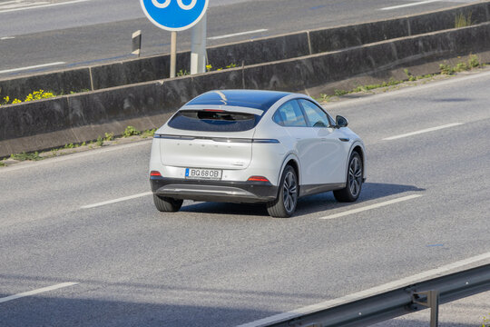 White xpeng electric suv driving on highway