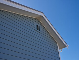 Fototapeta premium Modern House Exterior Showing Gray Vinyl Siding And Roof Ventilation System