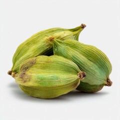 Close-up of green, ribbed cardamom pods, on a white surface. Details visible
