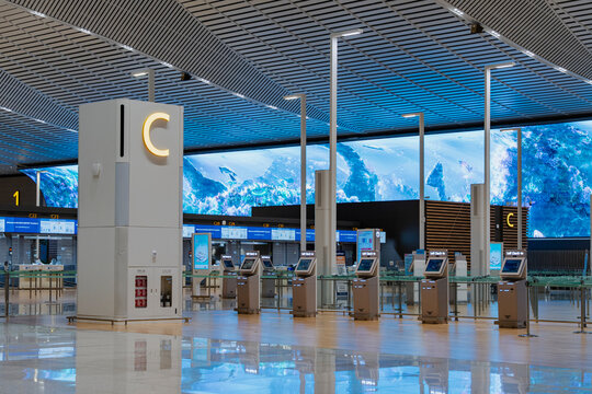 February 19, 2026, Incheon, South Korea - Empty Incheon International Airport Terminal 2 with self-check-in kiosks and large digital display.