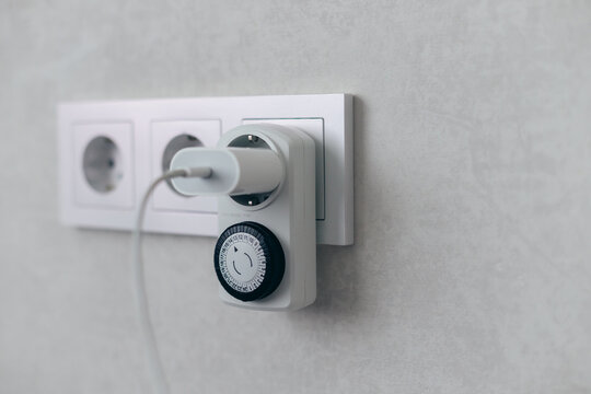 Mechanical Timer With USB Charger Plugged Into Wall Socket