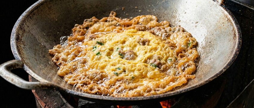 Golden Thai omelet Kai Jeow Moo Sab with minced pork and crispy edges macro