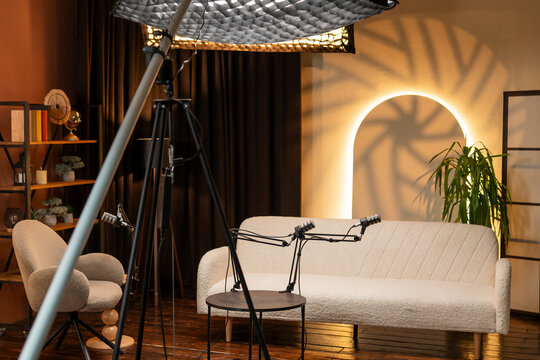 Podcast recording setup in a studio with lighting and microphones ready for conversation