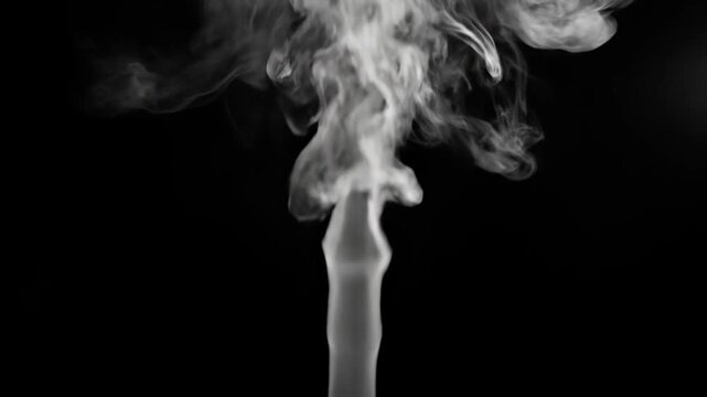 Smoke Rising From a Wick Against a Black Background.