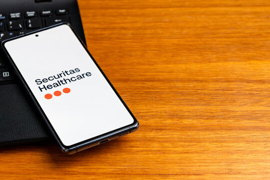 Punta Arenas, Chile &ndash; February 23, 2026: The Securitas Healthcare logo displayed on a smartphone screen resting on a black laptop keyboard
