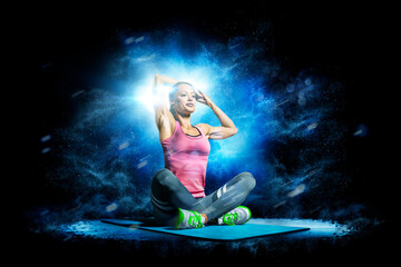 Fitness. Professional female fitness against a beautiful black background with a flash of light behind her. Isolated on a black background. © 103tnn