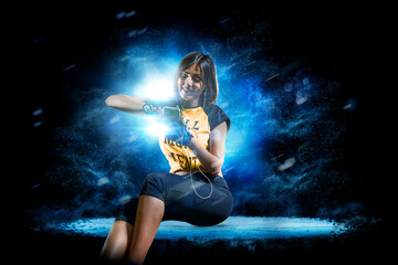 Fitness. Professional female fitness against a beautiful black background with a flash of light behind her. Isolated on a black background. © 103tnn