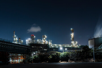 Fototapeta premium Industrial Complex Lit Against Night Sky, Chemical Processing Site