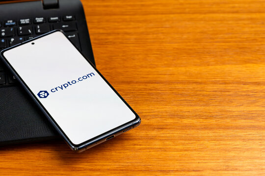 Punta Arenas, Chile &ndash; February 23, 2026: The Crypto.com logo, featuring the "Ethereum Lion" symbol, displayed on a smartphone screen resting on a laptop keyboard