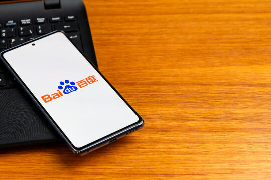 Punta Arenas, Chile &ndash; February 23, 2026: The Baidu logo, featuring its red and blue paw print emblem, displayed on a smartphone screen resting on a laptop