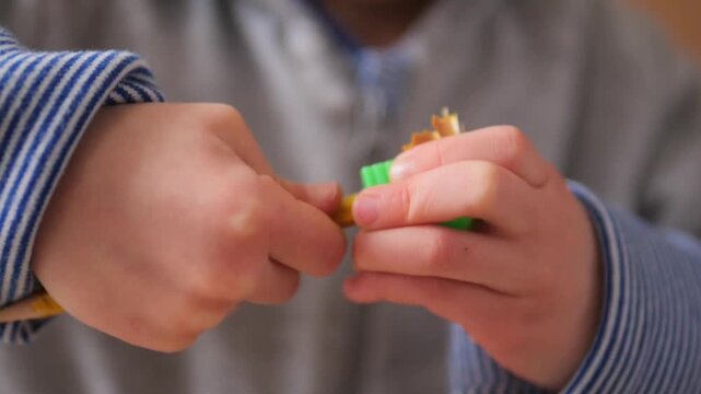 Slow Motion 180fps Macro of Mother Helping Child Sharpen Pencil for Creative Play