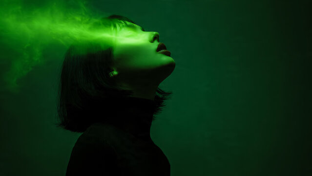 Femme en train de m&eacute;diter avec lumi&egrave;re verte symbolisant l'&eacute;nergie