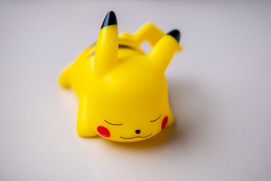 kawaii Yellow Pikachu figurine in relaxed sleeping pose, playful pop culture collectibles, nostalgic collectible nintendo gaming toy Pok&eacute;mon memorabilia fans and collectors, and casual decorators