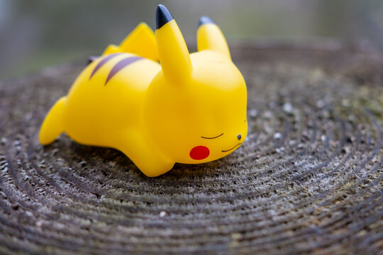 kawaii Yellow Pikachu figurine in relaxed sleeping pose, playful pop culture collectibles, nostalgic collectible nintendo gaming toy Pok&eacute;mon memorabilia fans and collectors, and casual decorators