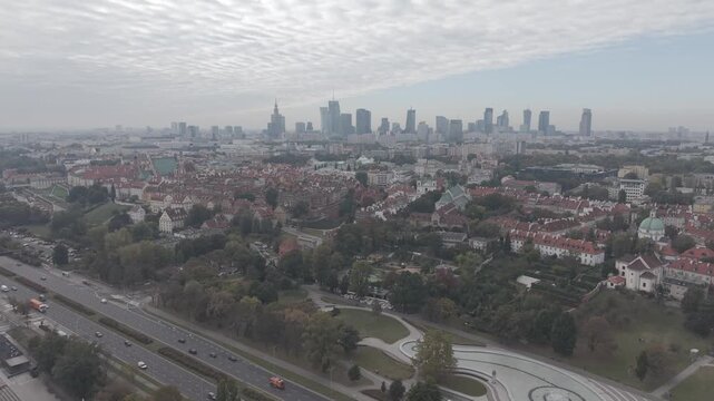 Aerial panoramic view of Warsaw city skyline with the Old Town in the foreground and modern skyscrapers in the distance. Slow pan from left to right