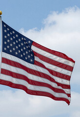 Fototapeta premium shot undulating american flag waving gently bright blue sky crisp white clouds breezy summer