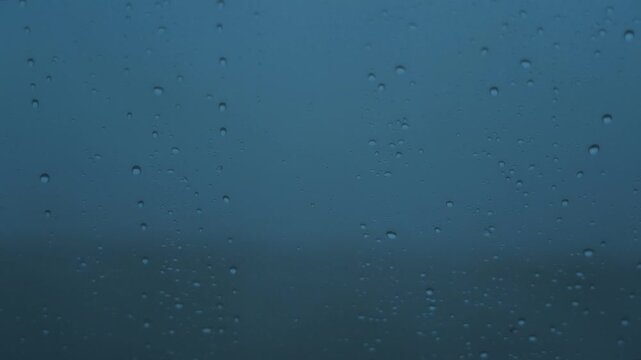 車の窓に落ちるみぞれ交じりの雨