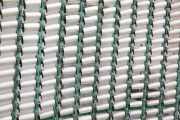 Fototapeta premium Many spools of silk thread. Weaving machine. Close-up