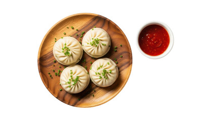 Delicious steamed dumplings served with spicy red sauce