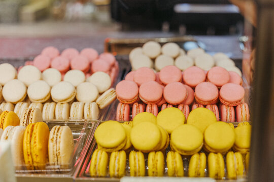 Various flavors of macrons in a display case at a bakery in Paris, France 