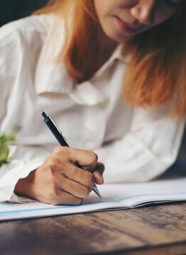 Planner plan Schedule Calendar and reminder agenda, work online at home. Woman hand planning daily appointment and write business trip in diary book at office desk. 