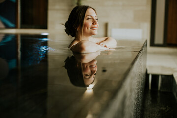 Woman relaxes in water at spa during daytime in calm setting