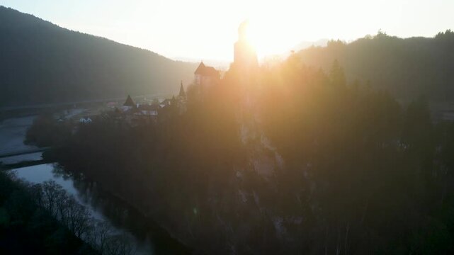 Aerial view Orava Castle above the river in sunset light. landscape, 4K, ProRes