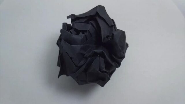 close up of a vibrant crumpled paper ball, symbolizing a discarded idea, mistake, or creative block.