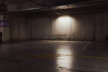 Empty parking lot with overhead dim light © Vlad Ispas