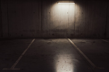 Empty parking lot with overhead dim light © Vlad Ispas