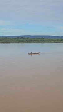 A fisherman in the distance fishing in the waters of the S&atilde;o Francisco River in Ibotirama, Bahia, Brazil.