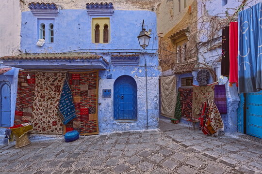 Tourist shops selling local rugs and carpets on Calle Targui and Rue Znika Streets in the medina, still closed in the morning. Chefchaouen-Morocco-049