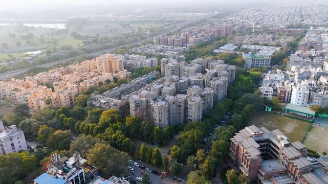 Top down cross traffic highway with cars, trucks aerial. Urban transportation at bridge road at Delhi. Cinematic cityscape of downtown freeway drone shot. Noida Freeway.