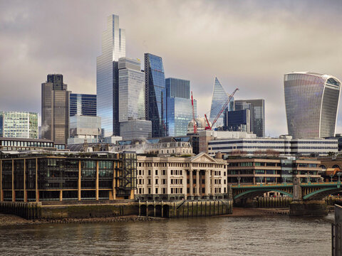 Panoramic view of the city skyline along the River Thames, featuring the neoclassical columned building at Vintners' Place, London, Great Britain