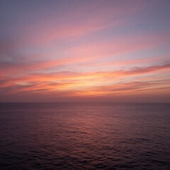 Obraz premium A serene ocean landscape at sunset with vibrant colors in the sky