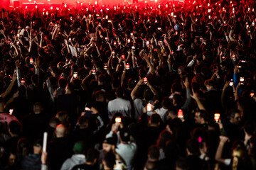 Crowd holding smartphones recording live music concert © Zoran Jesic