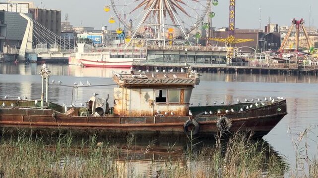 Basra, Iraq - Fabruary 11, 2026: A weathered fishing boat rests in the Shatt al-Arab waters.Basra, Iraq - Fabruary 11, 2026: A weathered fishing boat rests in the Shatt al-Arab waters.