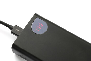 The power bank's charge indicator is 100%. The concept is to keep power banks charged during power outages.