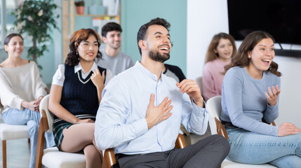 Female lecture attendees react positively and actively participate in discussions. People are...