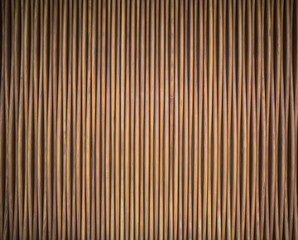Fototapeta premium Abstract Blurred Background of a Wall Made of Vertical Wooden Poles.